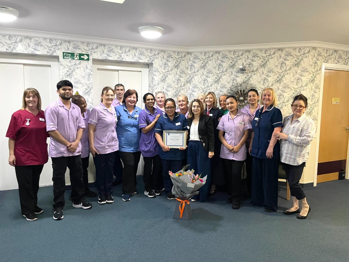 gilmerton care home staff smiling with nurse holding award nomination