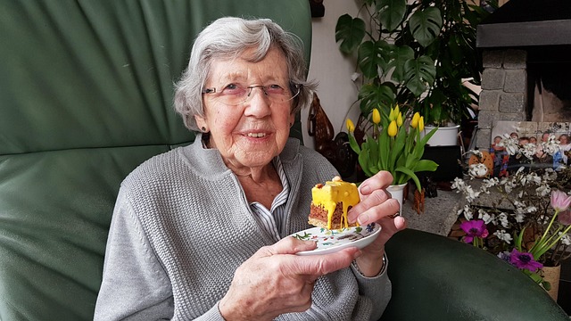 elderly woman enjoying some cake