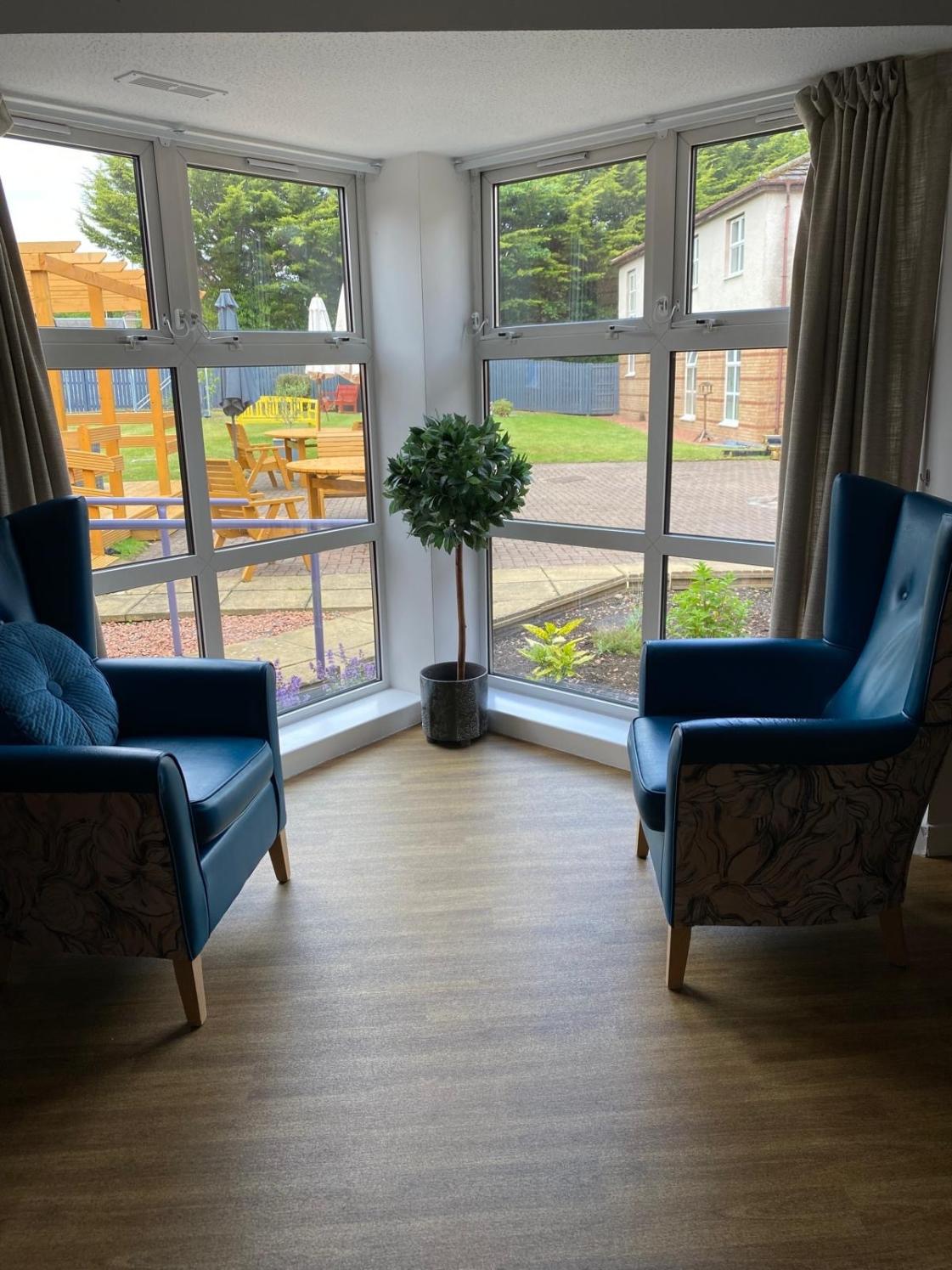 armchairs next to a large window