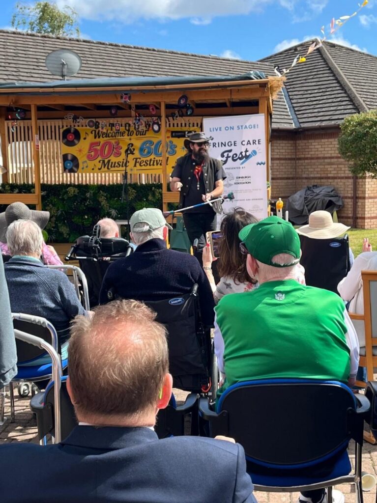 performer playing music for care home residents