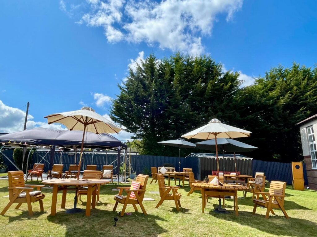 tables, chairs and parasols in care home garden